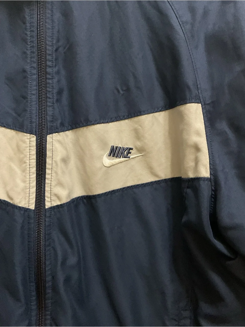 Vintage Nike Men’s Navy Blue Windbreaker with White Chest Stripe